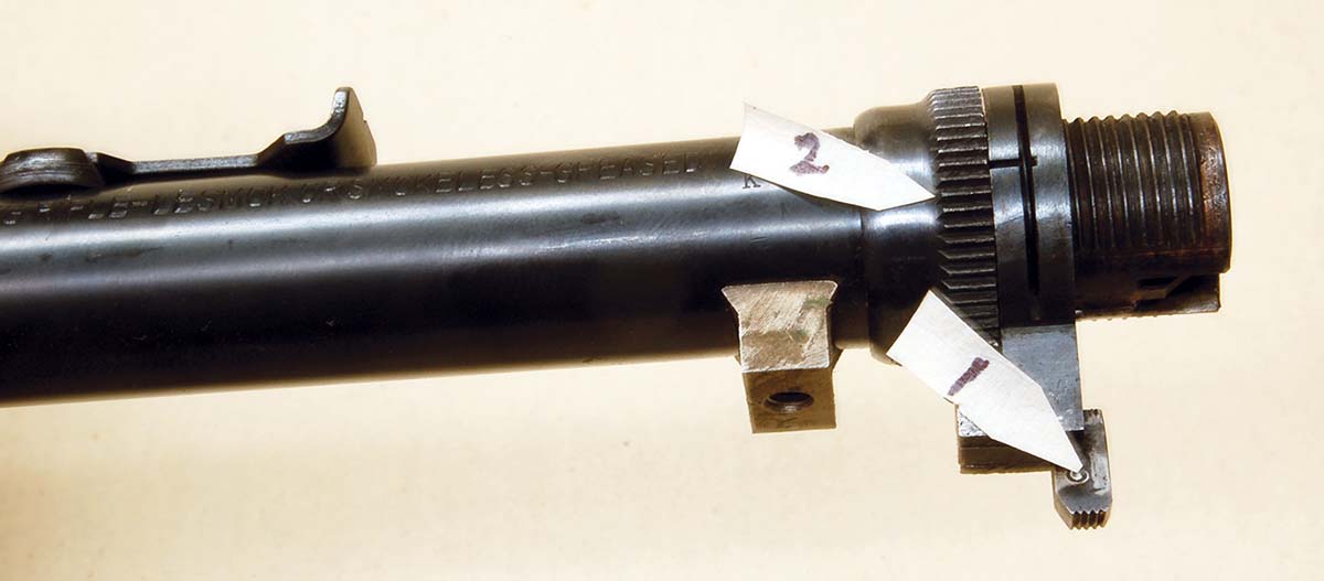 Takedown joint adjustment requires the forearm to be removed, then push the takedown button (1) to the left until the notched adjustment nut (2) can be turned. (See text for warning!)